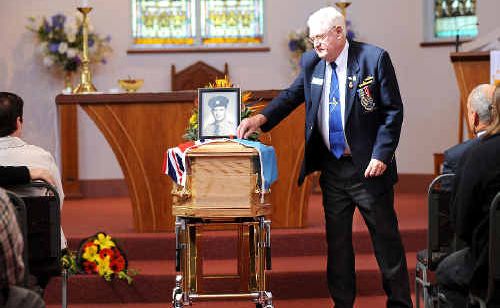 CHAMPION BLOKE: Max Lewis, president of the Ballina RSL Sub-branch, places a red poppy on the coffin of Stan Tilley during yesterday’s funeral service at St Mary’s Anglican Church in Ballina. CHAMPION BLOKE: Max Lewis, president of the Ballina RSL Sub-branch, places a red poppy on the coffin of Stan Tilley during yesterday’s funeral service at St Mary’s Anglican Church in Ballina.